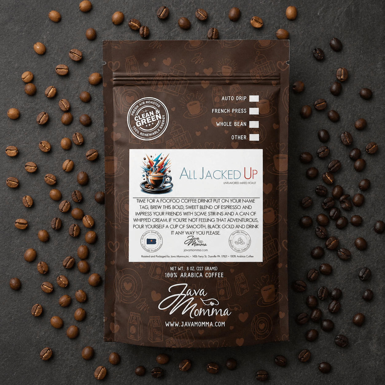 Java Momma All Jacked Up Espresso Blend coffee bag on a dark slate surface surrounded by scattered light and dark roast coffee beans
