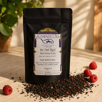 Thumbnail for Tea package labeled 'All That Razz' from Authenticici Tea with raspberries on a wooden surface.