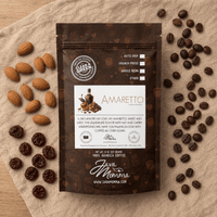 Thumbnail for Overhead flat lay of Java Momma Amaretto coffee bag on a textured linen cloth, surrounded by scattered raw almonds, dried cherries, and whole roasted coffee beans.