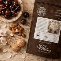 Thumbnail for Momma's Spellbook Collection Bundle with cherries, almonds, and coffee bag on a wooden table.