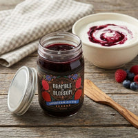Thumbnail for Jar of Bramble and Blossom spread on a wooden surface with a bowl of spread and berries.