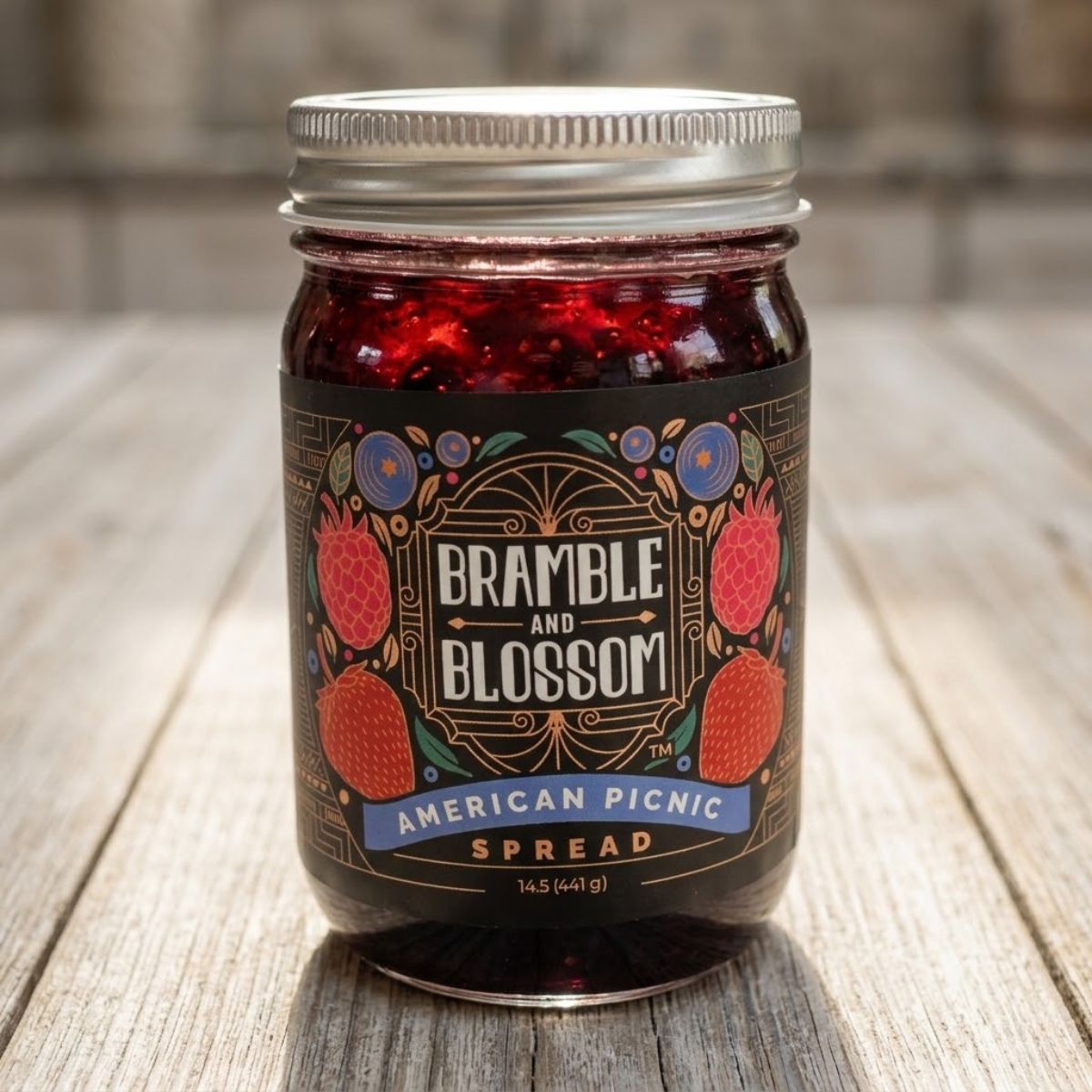 Jar of Bramble and Blossom American Picnic Spread on a wooden surface