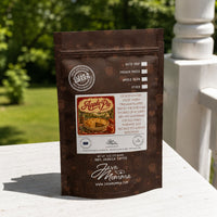 Thumbnail for Java Momma coffee package with Apple Pie flavor on a table outdoors