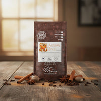 Thumbnail for A bag of Autumn Spice Flavored Coffee, a rich seasonal blend, rests on a rustic table with cinnamon sticks, nutmeg, and star anise nearby. A softly blurred background suggests a cozy indoor vibe.