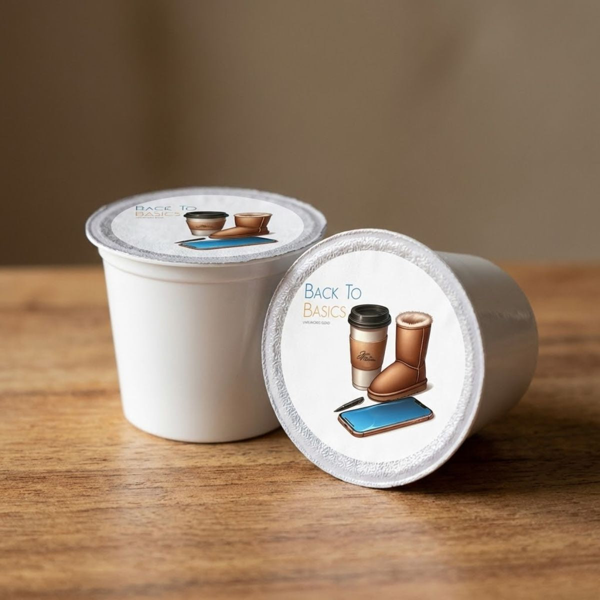 Two white coffee pods with 'Back To Basics' branding on a wooden surface.