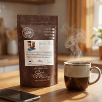 Thumbnail for Java Momma Back to Basics 
coffee package with a steaming cup of coffee on a wooden table.