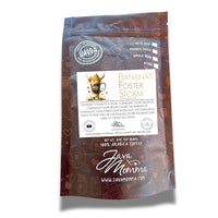 Thumbnail for A brown bag of Bananas Foster Storm – Medium Roast Coffee features cup art and details its caramelized banana, brown sugar, and rum notes. The 8 oz package contains 100% Arabica whole beans.