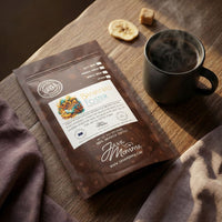 Thumbnail for Flat lay of medium roast coffee beans, cinnamon sticks, and dried banana slices.