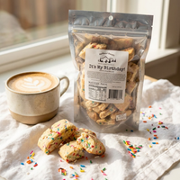 Thumbnail for Packaged cookies with a birthday message next to a cup of coffee on a light surface.