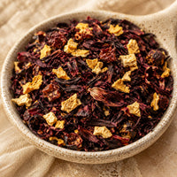 Thumbnail for Blood Orange Moon Tea leaves with orange peel pieces in a ceramic bowl on a beige background