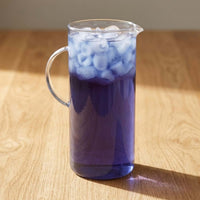 Thumbnail for Blue Tide Cold Brew Tea Pods in a pitcher filled with vibrant purple cold brew tea and ice cubes.