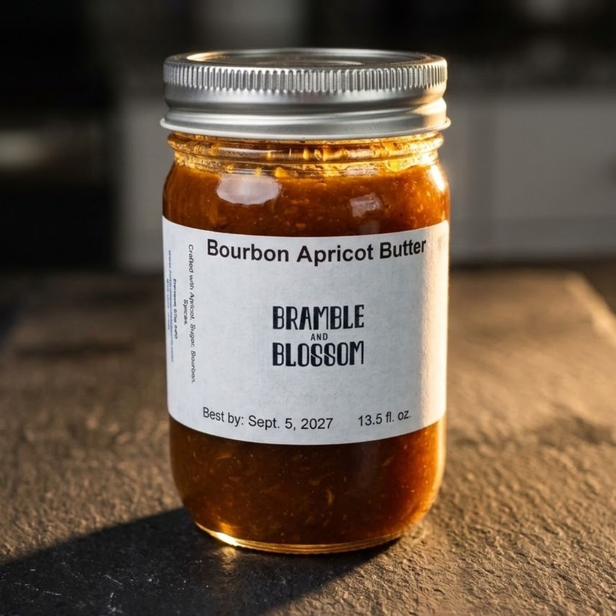 Jar of Bourbon Apricot Butter with a label on a textured surface
