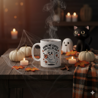 Thumbnail for Cute Halloween-themed mug with ghost design on a table with pumpkins, candles, and a cat.