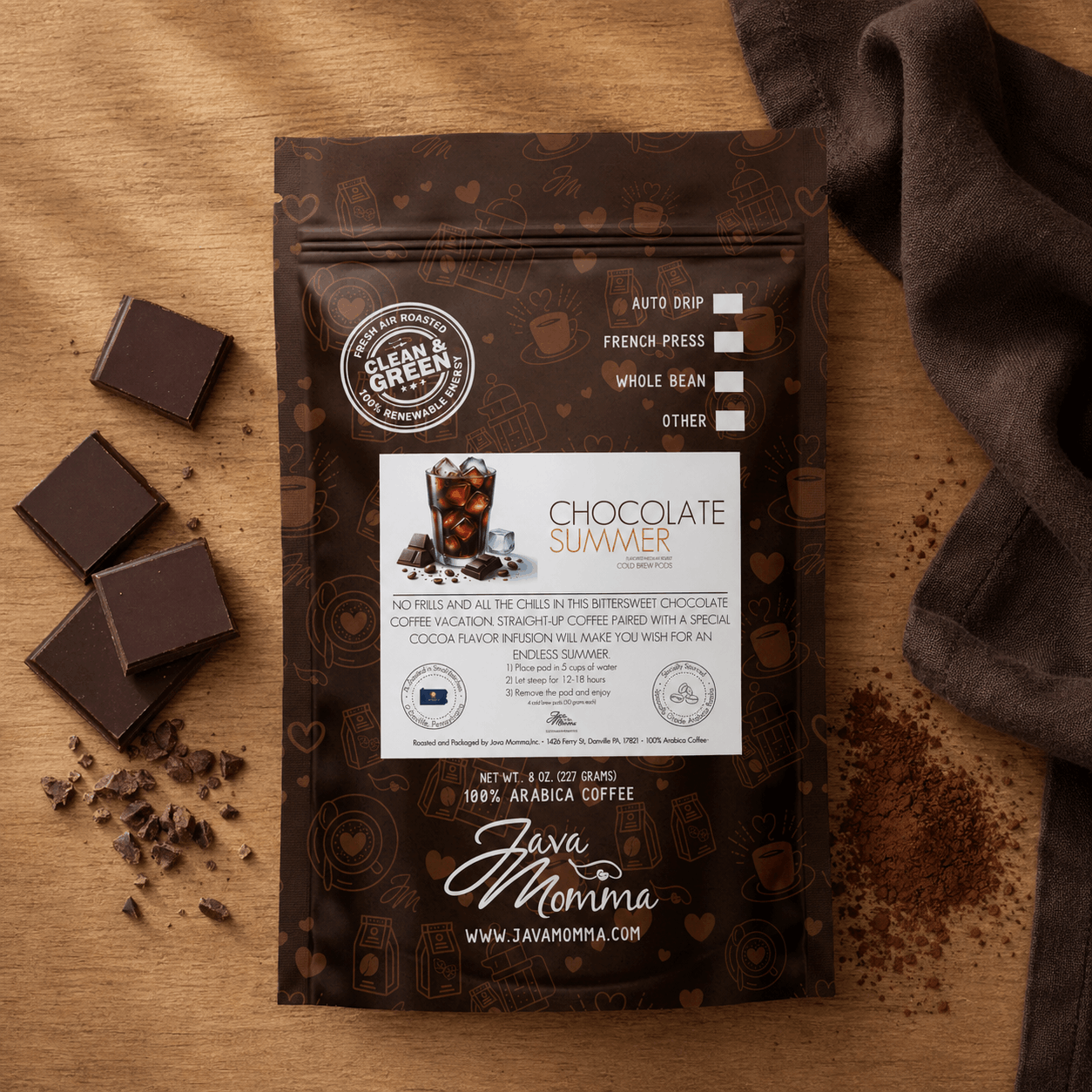 Java Momma Chocolate Summer cold brew coffee package with chocolate pieces on a wooden surface