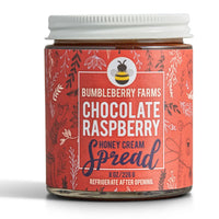 Thumbnail for An 8 oz jar of Chocolate Raspberry Honey Cream Spread 🍫 – Award-Winning, Rich & Fruity Chocolate Bliss, with a red, nature-themed label featuring leaves and a bear illustration, plus a white lid. SOFI Gold Winner by Bumbleberry Farms.