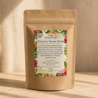 Thumbnail for Coconut Banana Dream tea in Kraft paper tea bag with colorful label on a wooden surface