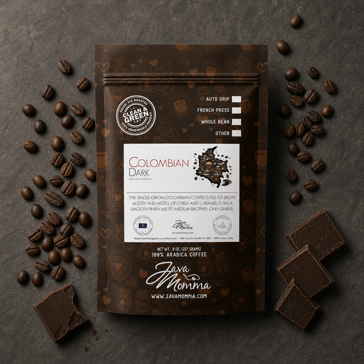 Overhead flatlay of Colombian Dark Roast bag with dark roast coffee beans and dark chocolate pieces