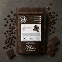 Thumbnail for Overhead flatlay of Colombian Dark Roast bag with dark roast coffee beans and dark chocolate pieces