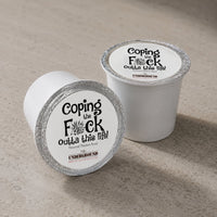 Thumbnail for Two white coffee pods with black text on a beige surface