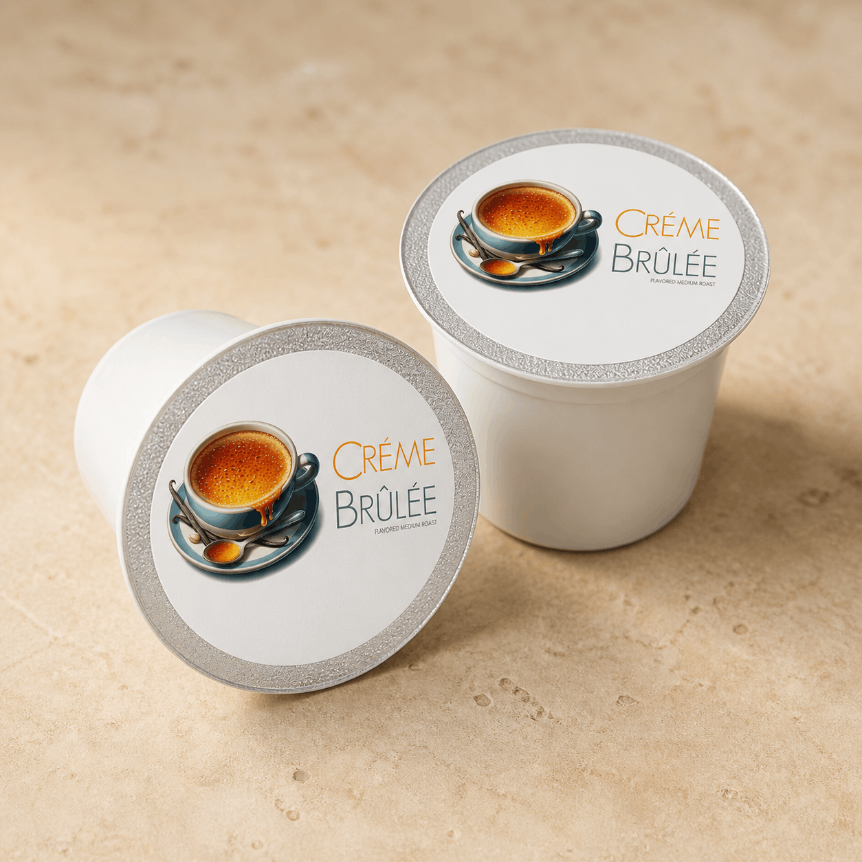 Two coffee pods labeled 'Crème Bruleé' on a beige surface