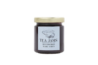 Thumbnail for A glass jar from the Mini Tea Jams Gift Set 🍯 contains handcrafted Blueberry Earl Grey tea-infused jam with a gold lid and label featuring a teacup, blueberries, and tea leaves—flavors inspired by Harney & Sons teas.