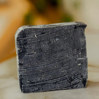Thumbnail for A close-up of the No Tox Life Underarm Detox – Deodorant Booster Cleansing Bar (19.3g), featuring textured lines and specks on a light surface—an ideal aluminum-free, natural deodorant alternative for a fresher feel.
