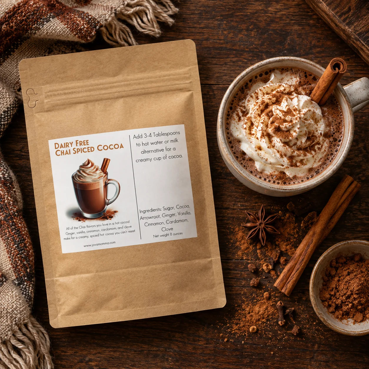 Dairy Free Dark Chai Spiced Hot Cocoa Mix package next to a mug of hot cocoa topped with whipped cream and spices.