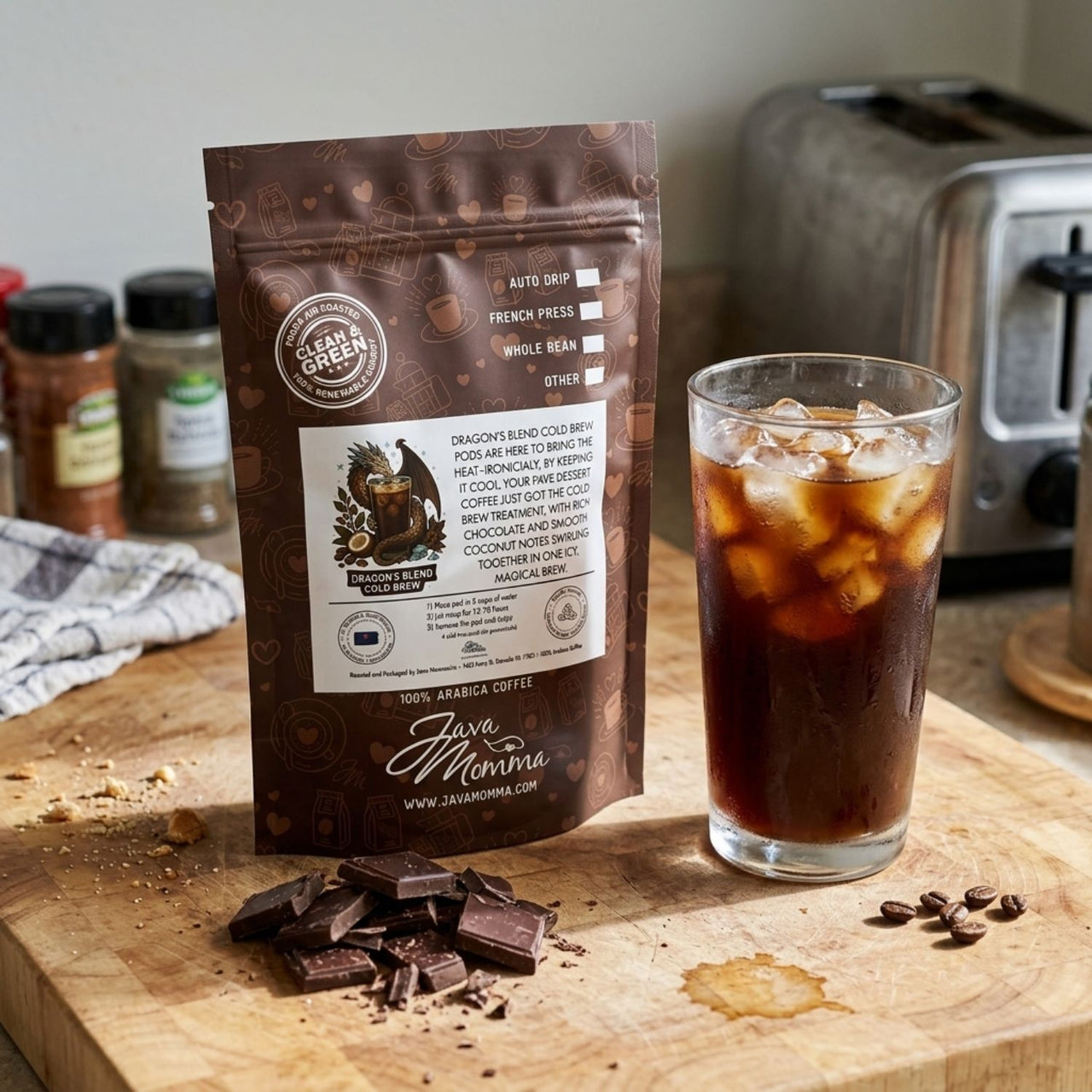 Java Mama Dragon's Blend cold brew coffee package with iced coffee on a wooden cutting board