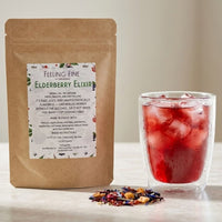 Thumbnail for Elderberry elixir package with a glass of iced tea on a neutral background
