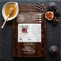 Thumbnail for Overhead flat lay of Java Momma Fig & Honey Coffee bag on dark slate surrounded by fresh and dried figs, a honey dipper, and dried lavender