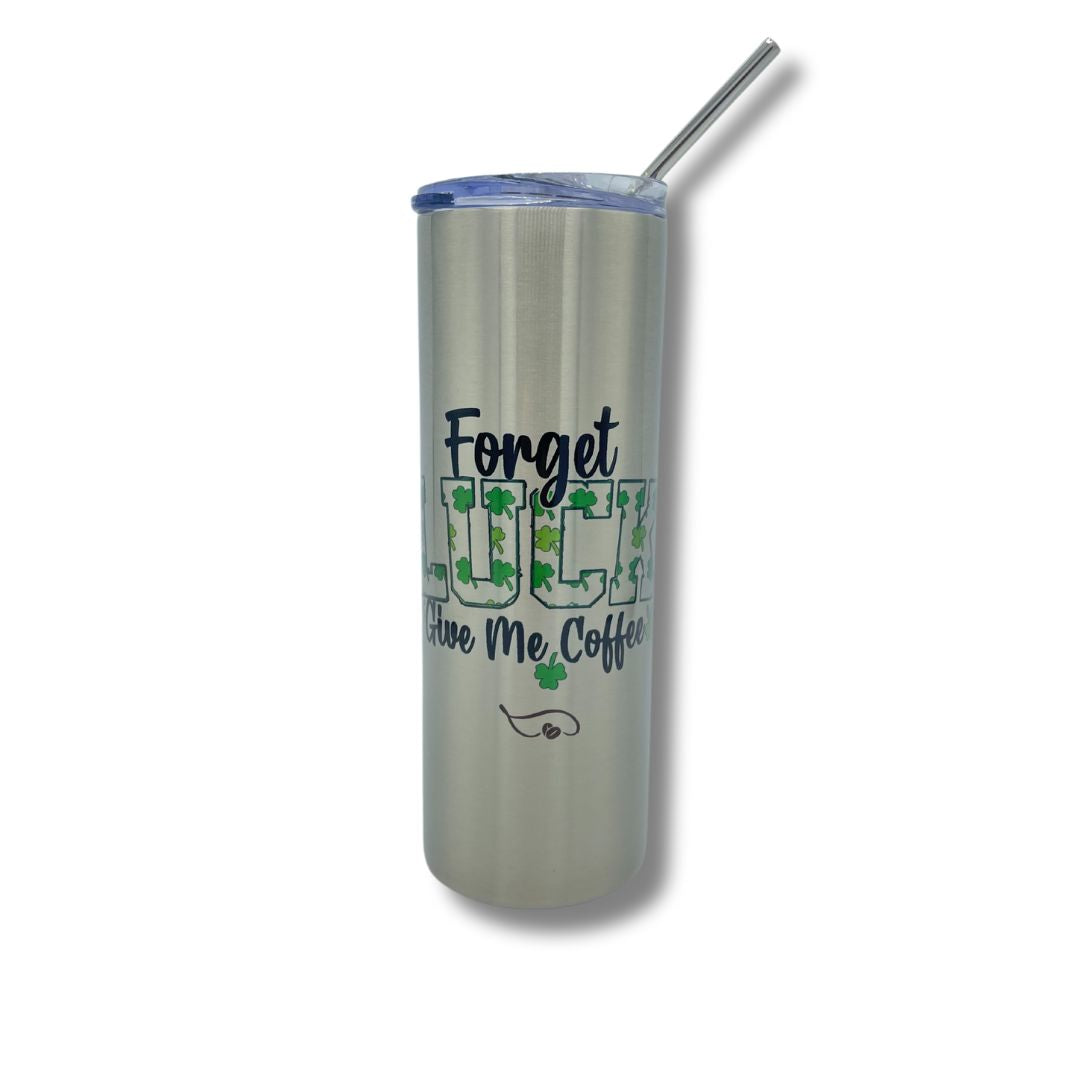 A close-up of the Forget Luck, Give Me Coffee tumbler against a white background. The stainless steel finish and shamrock-filled lettering stand out, while the clear lid and straw make it a stylish, functional choice for both hot and iced drinks. Perfect for anyone celebrating St. Paddy’s Day with caffeine in hand!
