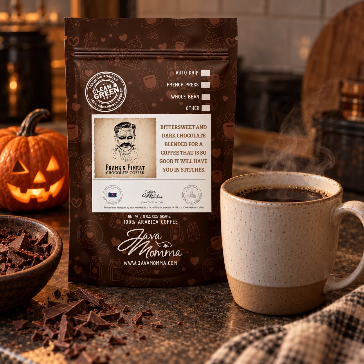 A bag of Frank's Finest Coffee. 'Bittersweet and Dark Chocolate' coffee stands on a countertop beside a cup of hot coffee, with chocolate pieces in a bowl and a pumpkin in the background.
