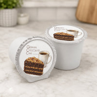 Thumbnail for Two German Chocolate Cake coffee pods on a marble surface with a blurred background.