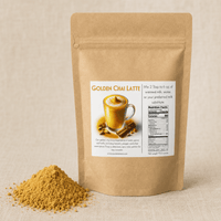 Thumbnail for A stand-up kraft paper pouch labeled Golden Chai Latte stands on a beige fabric surface with a small pile of the loose yellow-brown spice mix in front. The front label shows a cup of latte, spices, and nutrition facts.
