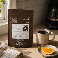 Thumbnail for Java Momma Guatemalan Medium Roast coffee bag next to a mug of coffee and a fresh orange slice