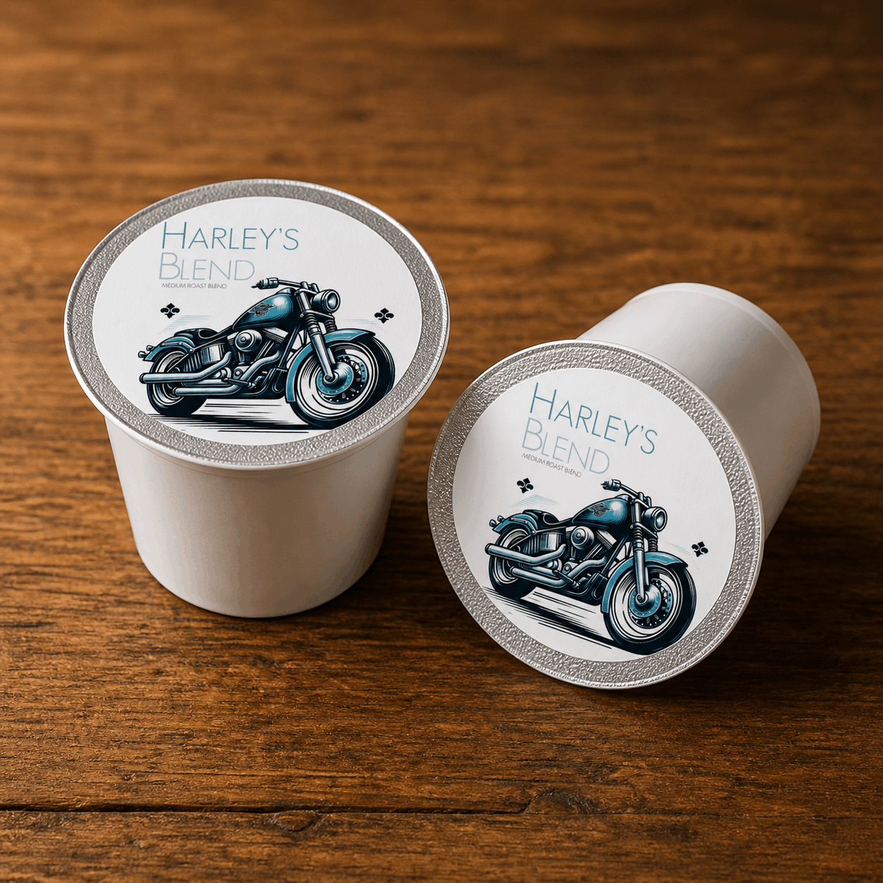 Two coffee pods labeled 'Harley's Blend' with motorcycle design on a wooden surface