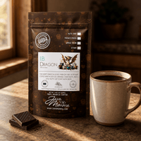 Thumbnail for I.B. Dragon coffee bag next to a ceramic mug with dark chocolate pieces on the side