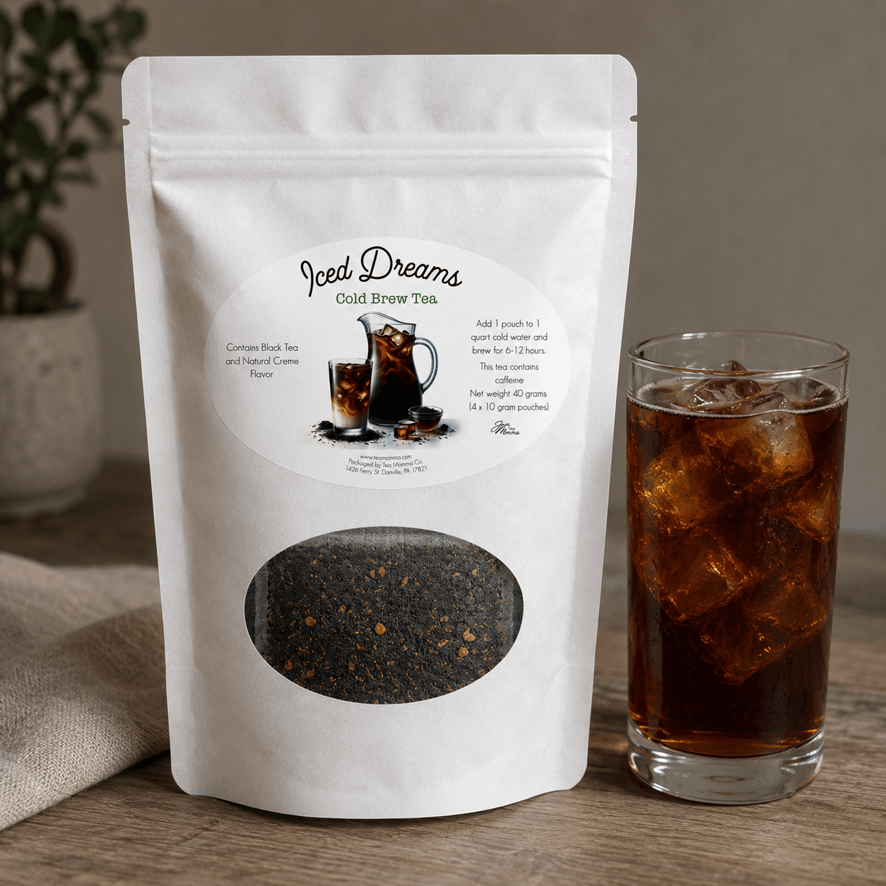 Iced Dreams Cold Brew Tea package with a glass of iced tea on a wooden surface.