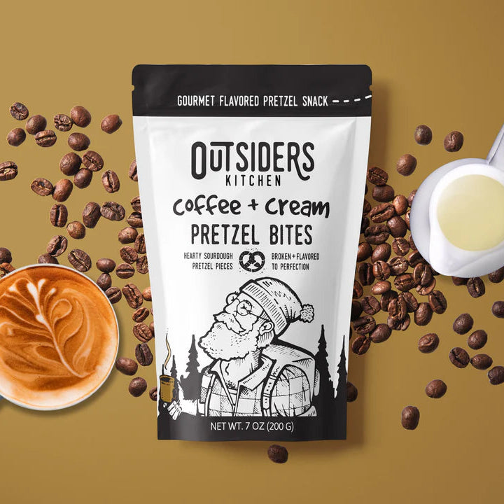 Coffee + Cream Pretzel Bites – Sweet, Salty, and Seriously Addictive ☕✨ sit among coffee beans, a latte, and cream on a light brown background—ideal for anyone craving small batch snacks.