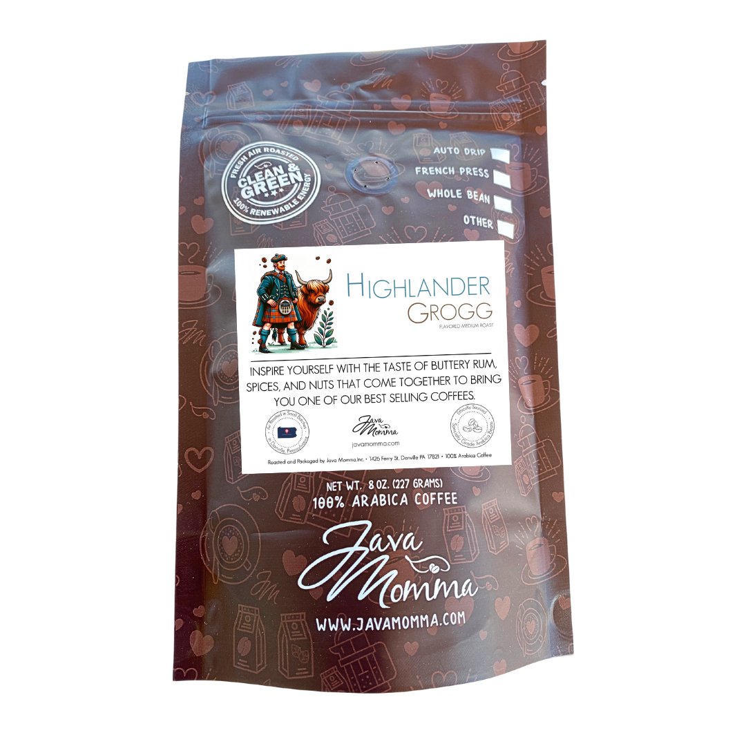 A brown bag of Highlander Grogg – Medium Roast Flavored Coffee features an illustrated kilted man and a cow on the label, with buttery rum, spice, and nut flavors. Available in whole bean and ground options.