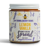 Thumbnail for A jar of Lemon Vanilla Honey Cream Spread 🍋 – Tart, Sweet & Totally Irresistible, with a white lid. The label showcases yellow and purple botanicals, a bee, and a bear, plus bold text for this luscious whipped honey cream.