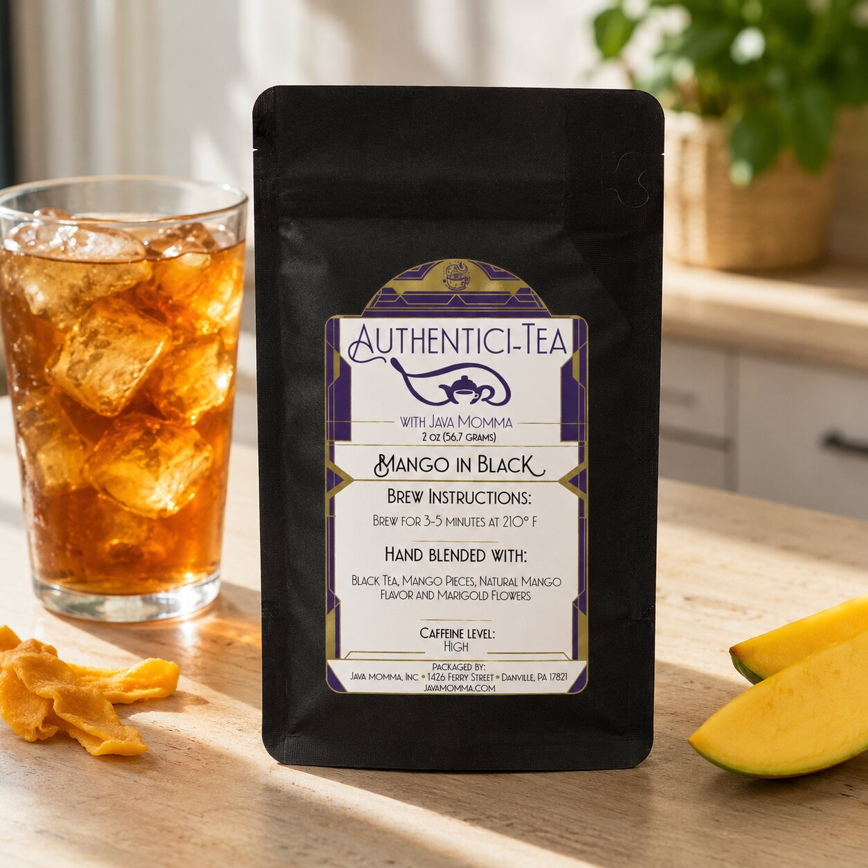 Authentic Tea Mango in Black 
package with a glass of iced tea and mango slices on a wooden surface.