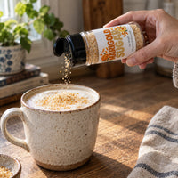 Thumbnail for Marigold Sugar Sprinkle being added to a frothy beverage in a cozy setting.