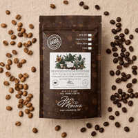 Thumbnail for Java Momma Momma's Blend coffee bag on a linen surface surrounded by scattered light and dark roast coffee beans