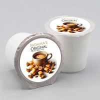 Thumbnail for Two coffee pods labeled 'Momma's Original' on a gray background