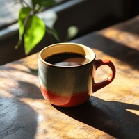 Thumbnail for Ceramic mug filled with Momma's Revenge coffee on a sunlit wooden table, showcasing the rich color and warmth of a fresh brew.