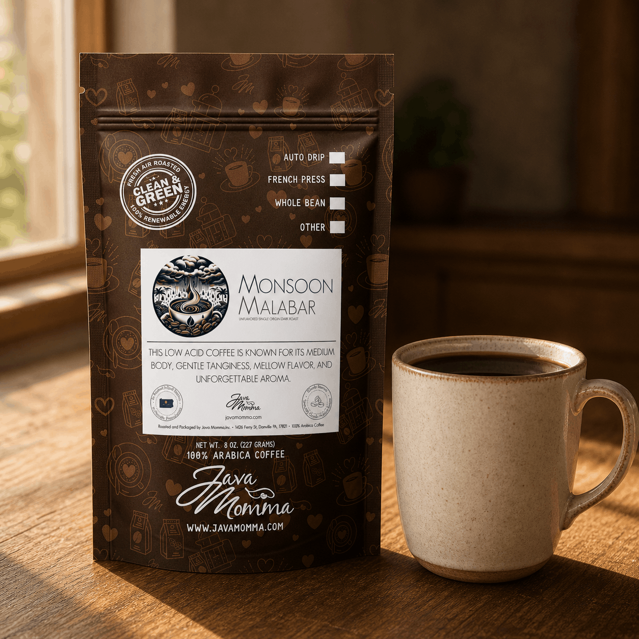 Indian Monsoon Malabar coffee bag next to a ceramic mug on a warm surface with natural light