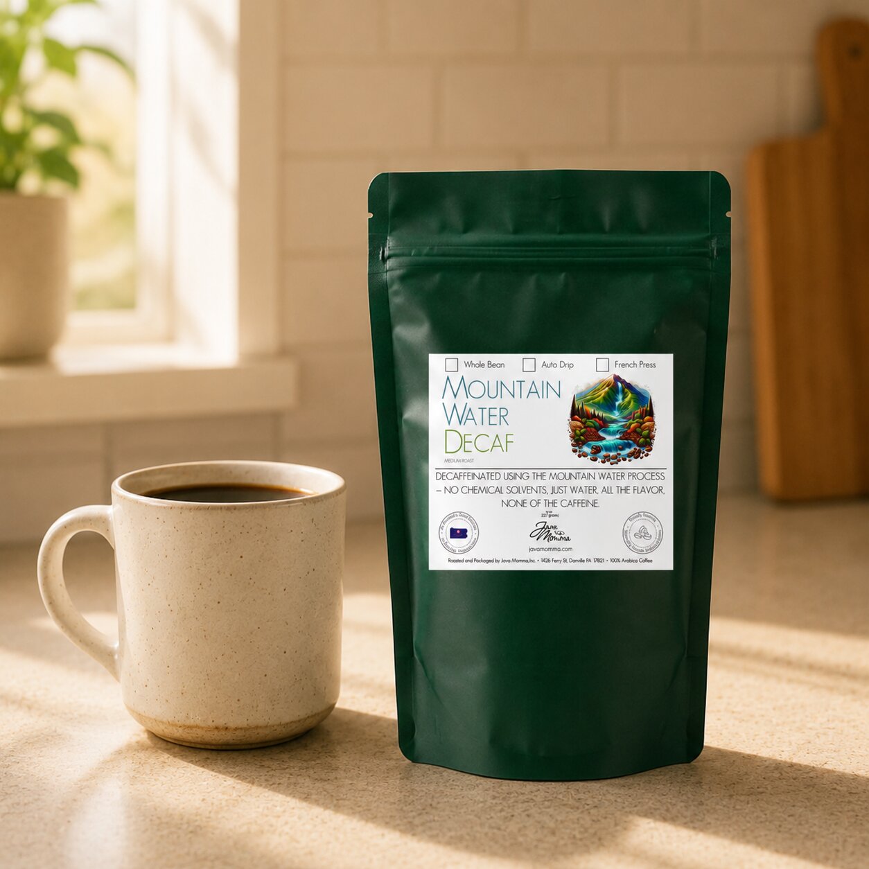 Java Momma Decaf coffee package and cup on a wooden surface with a window in the background