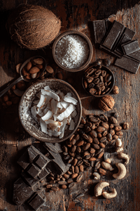 Thumbnail for Assorted chocolate, nuts, and coconut on a wooden surface