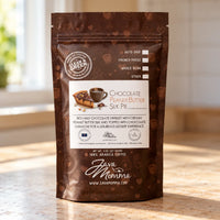 Thumbnail for A stand-up pouch of Java Mama Clean Green Chocolate Peanut Butter Suk Pie coffee beans, standing on a wooden table with a softly blurred kitchen background.